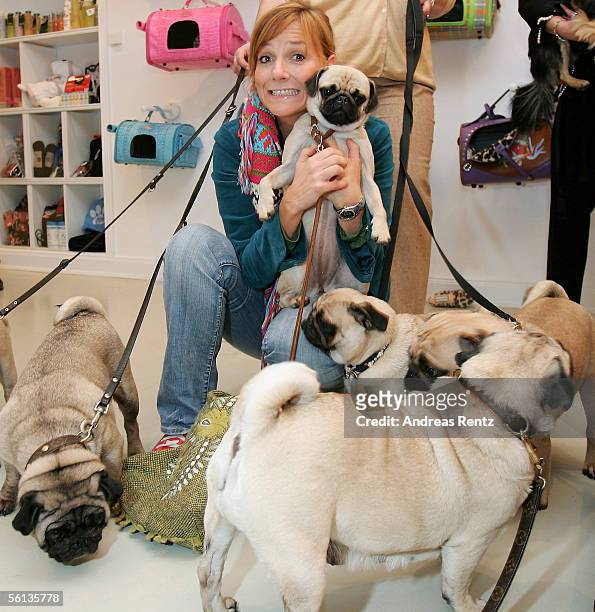 Singer and television hostess Kim Fischer, gestures with her dog Ella at the pre-opening of the new "Lifestyle Store for Dogs," a luxury accessories...