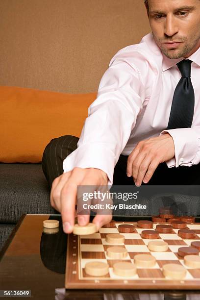 businessman playing checkers - checkers game ストックフォトと画像