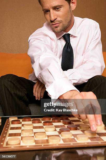 businessman playing checkers - checkers game ストックフォトと画像