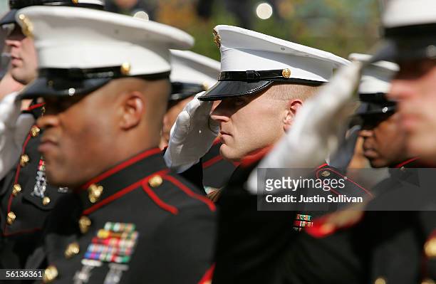 Members of the U.S. Marine Corp honor guard salute during the singing of the National Anthem during the unveiling ceremony for the new "Distinguished...
