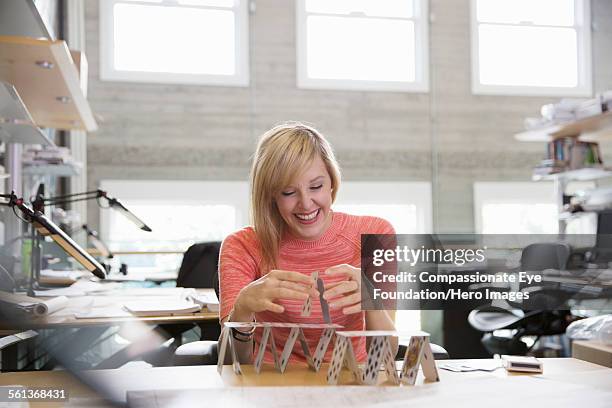 businesswoman making house of cards in office - house of cards stock pictures, royalty-free photos & images