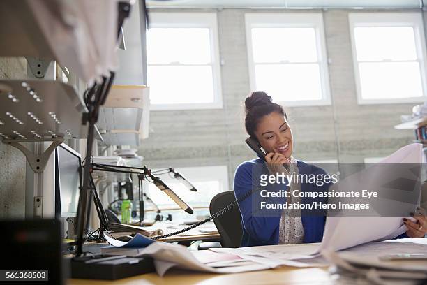 businesswoman using phone in modern office - festnetzanschluss stock-fotos und bilder