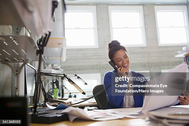 businesswoman using phone in modern office - landline telephone stock pictures, royalty-free photos & images