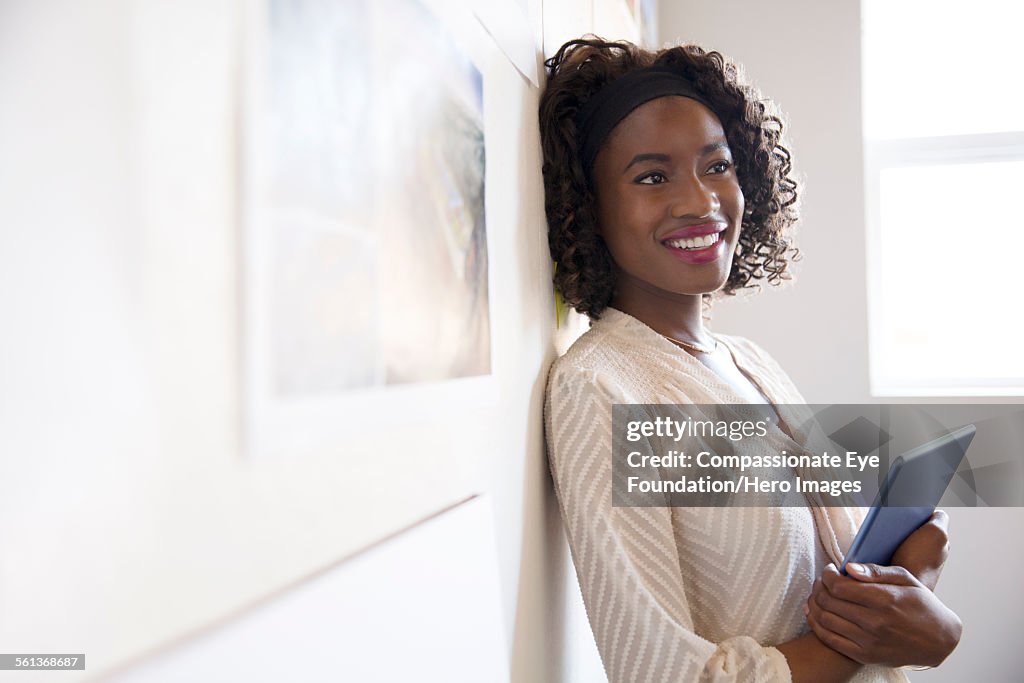 Smiling businesswoman using digital laptop in offi