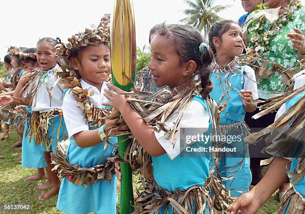 Children from Niue Primary School pass the Melbourne 2006 Queen's Baton during the Nuie leg of the baton's journey November 10, 2005 in Niue. The...