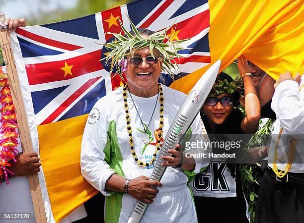 Young Vivian, Premier of Nuie, carries the Melbourne 2006 Queen's Baton during the Nuie leg of the baton's journey November 10, 2005 in Niue. The...