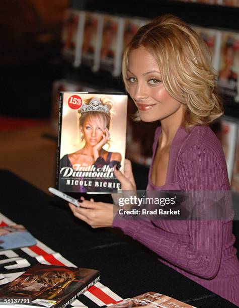 Nicole Richie poses with her new book "The Truth About Diamonds" at the Virgin Mega Store in Times Square on November 10, 2005 in New York City.