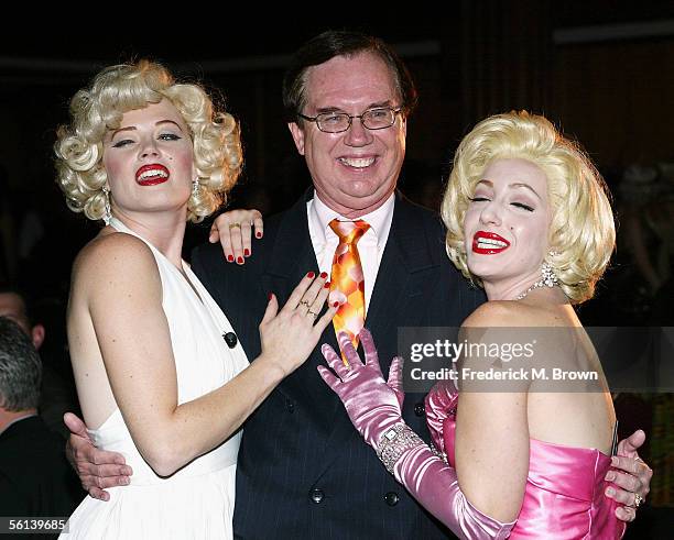 Collector Robert Otto and Marilyn Monroe impersonators pose for photograpers during a reception for the unveiling of the Marilyn Monroe Exhibit at...