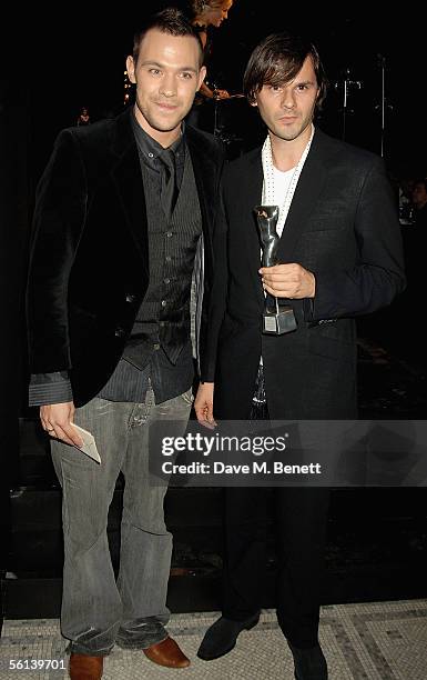 Will Young and Carlo Brandelli pose in the awards room with the award for "Menswear designer" at the British Fashion Awards at the Victoria & Albert...
