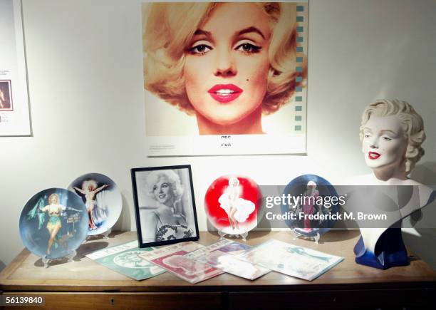 Photographs and other items owned by the late actress Marilyn Monroe is displayed during the unveiling of the Marilyn Monroe Exhibit at the Queen...
