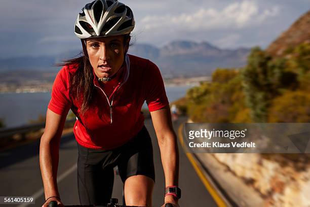 close-up of cyclist taking lead on mountain climb - posizione sportiva foto e immagini stock