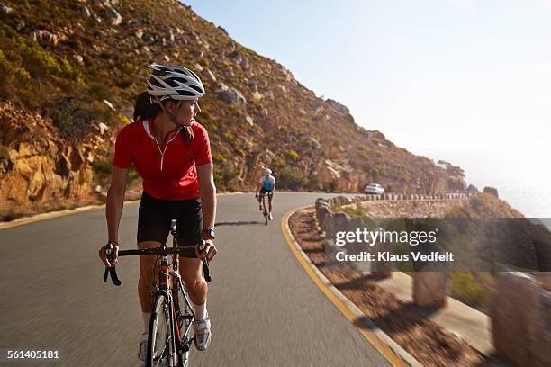 Female pro cyclist taking lead on mountain climb