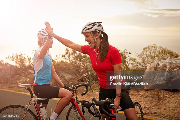 bikeriders & training partners doing high-five - sports training bildbanksfoton och bilder