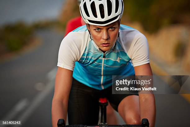 Close-up of cool female pro cyclist riding