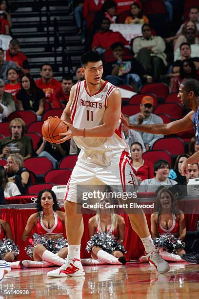 Yao Ming of the Houston Rockets looks to move the ball during a preseason game against the Washington Wizards at Toyota Center on October 23, 2005 in...