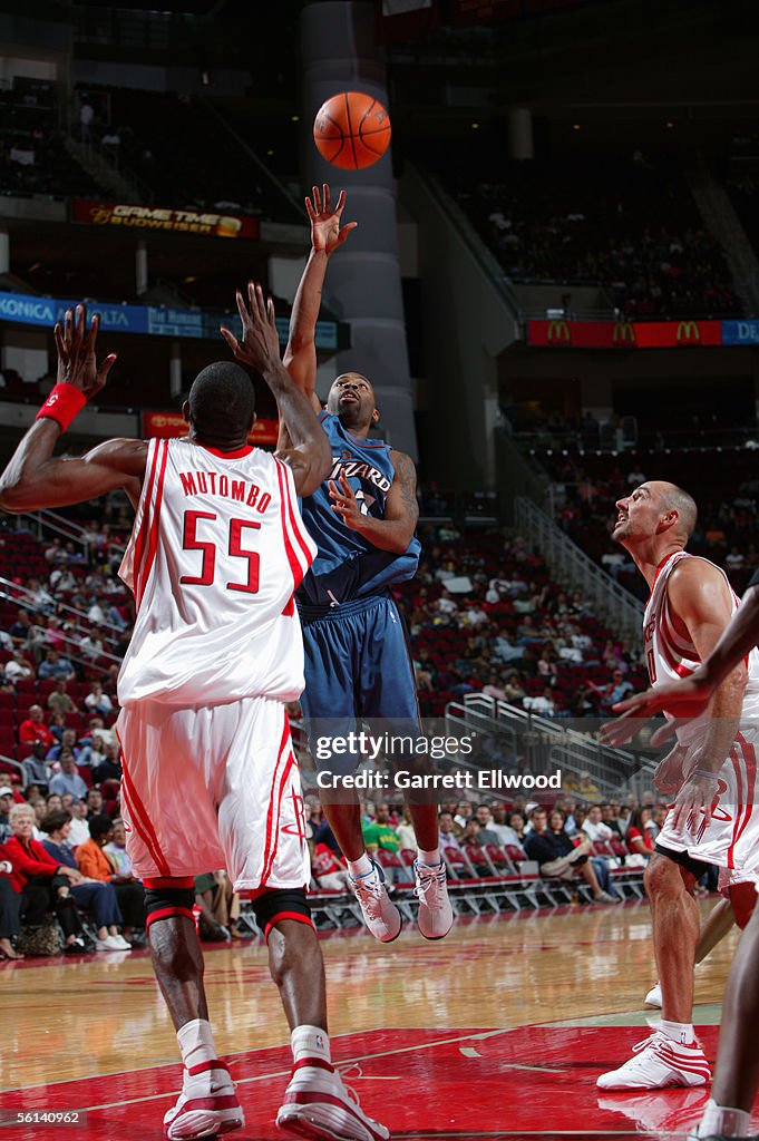 Wizards Rockets Chucky Atkins of the Washington Wizards shoots over Dikembe Mutombo ...