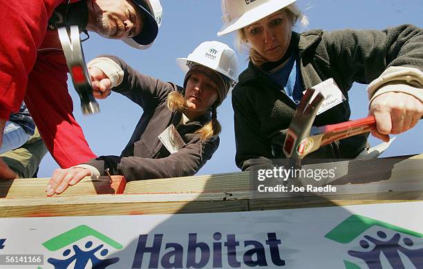 Jennifer Bremmer and Elizabeth Bowen and other volunteers work on building a Habitat for Humanity home during Operation Home Delivery November 11,...