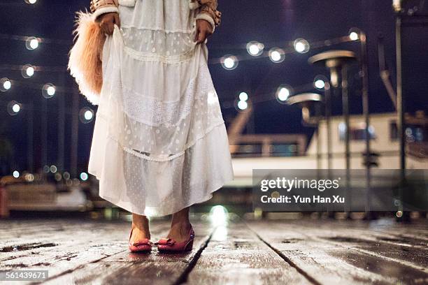 girl walking on the dock in the rain at night - girl rain night stock pictures, royalty-free photos & images