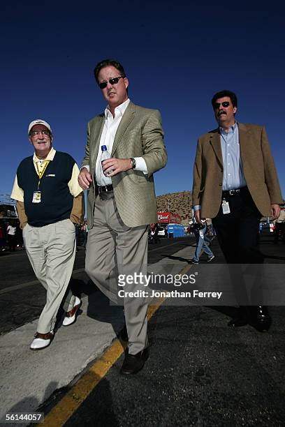 Brian France walks with NASCAR President Mike Helton and NASCAR Vice President of Communications Jim Hunter walk through the garage during practice...