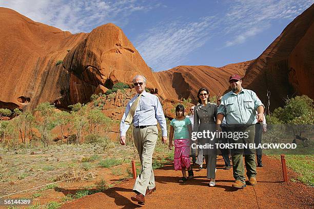 King Carl XVI Gustaf of Sweden and Queen Silvia walk with ranger Mick Starkey and his daughter Shania from Mutitjulu waterhole in Uluru-Kata Tjuta...