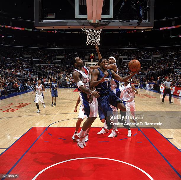 Rashad McCants of the Minnesota Timberwolves drives to the basket against Cuttino Mobley and James Singleton of the Los Angeles Clippers during a...