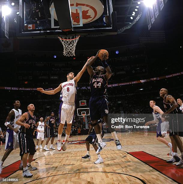 Marc Jackson of the New Jersey Nets goes to the basket against Jose Calderon of the Toronto Raptors during a game at Air Canada Centre on November 4,...