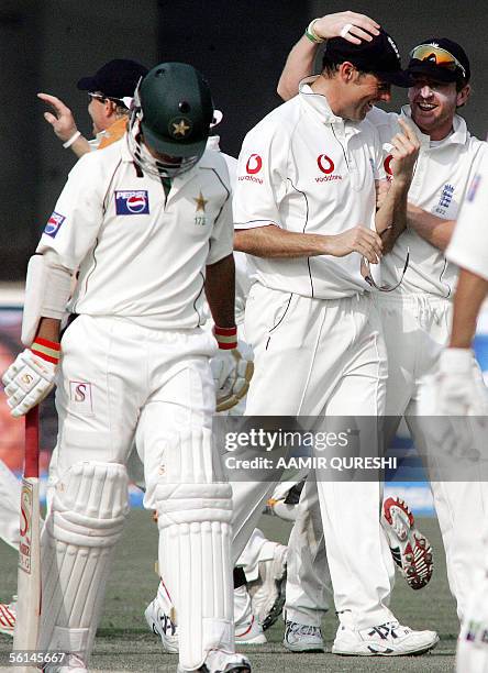 England captain Marcus Trescothick celebrates with a teammate after dismissing off Pakistani batsman Salman Butt during the opening day of first Test...