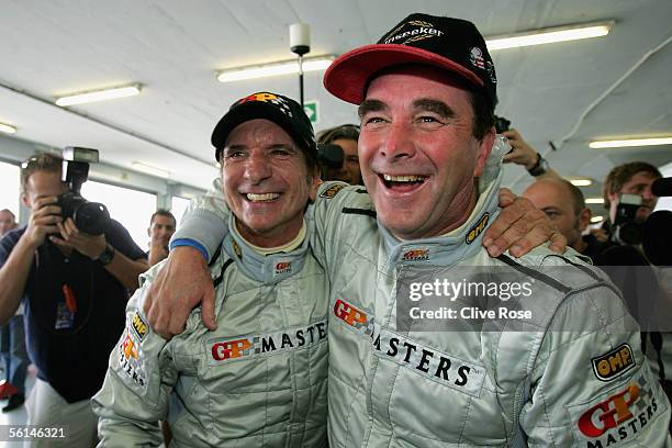 Nigel Mansell of Great Britain celebrates his pole position with Emerson Fittipaldi in Qualifying for the Grand Prix Masters race at the Kyalami...