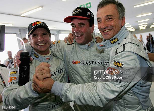 Nigel Mansell of Great Britain celebrates his pole position with Emerson Fittipaldi and Ricardo Patrese after Qualifying for the Grand Prix Masters...