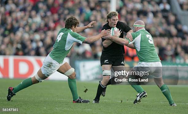 New cap Jason Eaton runs through the tackle of Donnch O'Callaghan and John Hayes during the international Rugby match between Ireland and New Zealand...