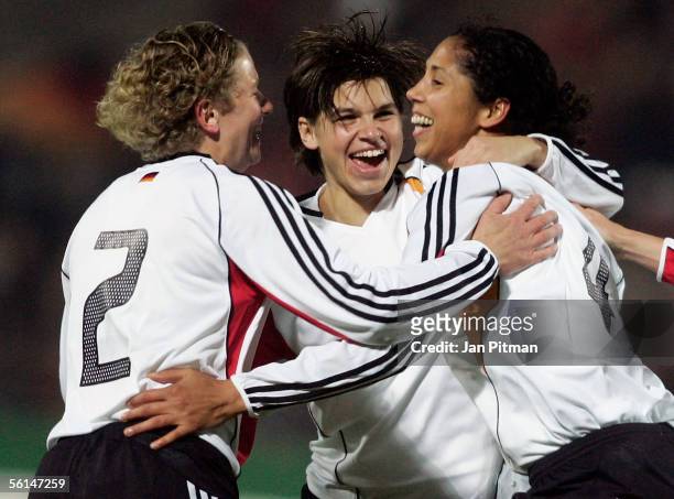 Steffi Jones, Ariane Hingst and Kerstin Stegemann of Germany celebrate after Jones scored 1-0 during the Women FIFA World Cup 2007 qualifier between...