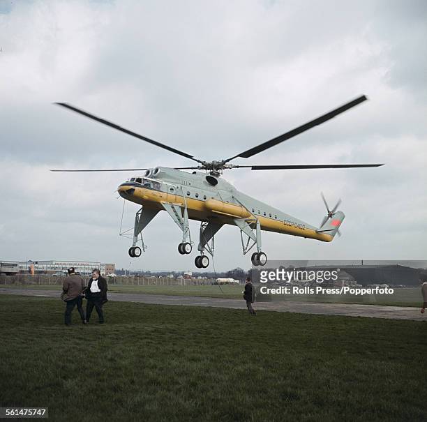 Giant Russian built Mil Mi-10 flying crane helicopter, capable of lifting 25 tons of cargo between its special wide quadricycle landing gear, takes...