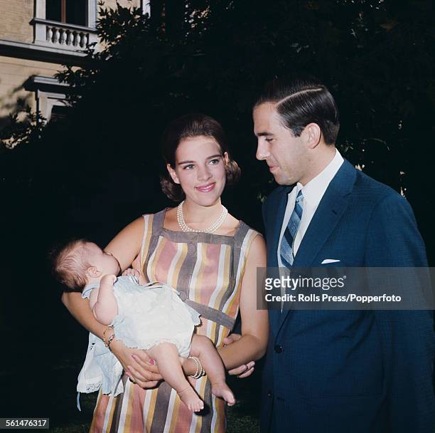 King Constantine II of Greece pictured with Queen Anne-Marie of Greece and their daughter Princess Alexia in 1965.