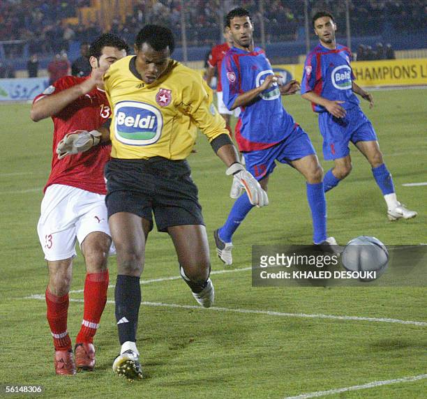 Tunisian Etoile du Sahel goallkeeper Ejide Austine vies with Egyptian Al-ahli Emad Meteeb in an African Champions League football final 12 November...