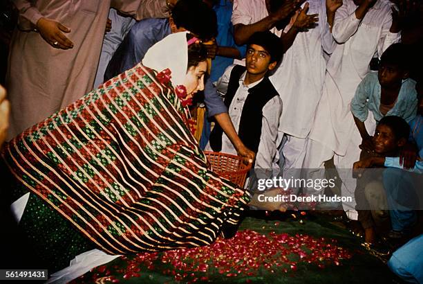 Former Prime Minister of Pakistan, Benazir Bhutto , leader of the Pakistan Peoples Party , scattering petals during the Pakistani General Election,...