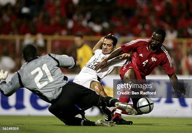 Salmon Isa Ghuloom Ali of Bahrain is tackled by Marvin Andrews and Kelvin Jack of Trinidad during the FIFA World Cup Playoff, 1st Leg match between...