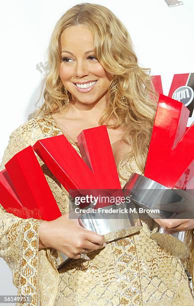 Singer Mariah Carey poses with her R&B Voice of the Year, Best R&B Song of the Year and Artist of the Year award in the press room at the 3rd Annual...