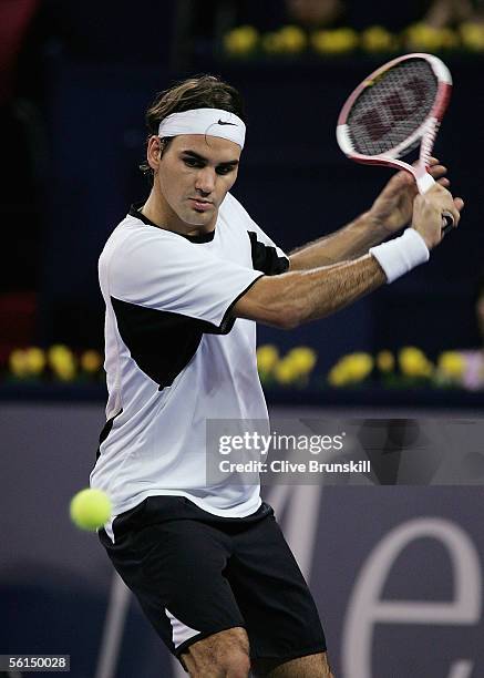 Roger Federer of Switzerland plays a backhand against David Nalbandian of Argentina in his first match of the round robin at the Tennis Masters Cup,...