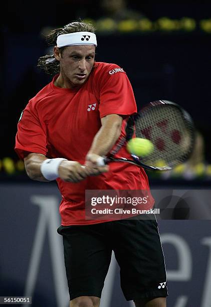David Nalbandian of Argentina plays a backhand against Roger Federer of Switzerland in his first match of the round robin at the Tennis Masters Cup,...