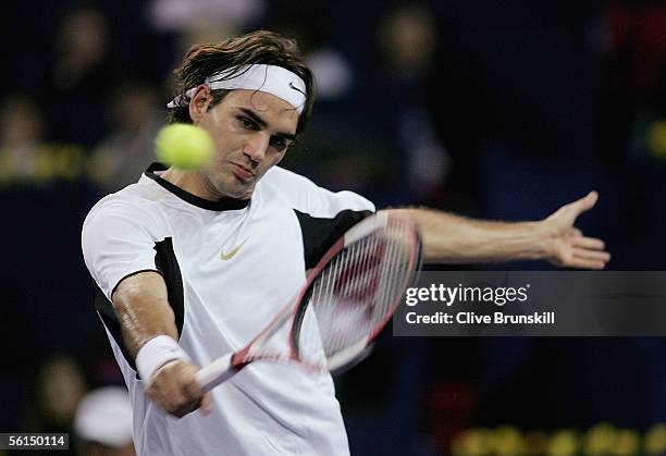 Roger Federer of Switzerland plays a backhand against David Nalbandian of Argentina in his first match of the round robin at the Tennis Masters Cup,...