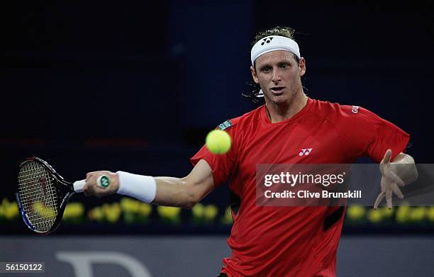 David Nalbandian of Argentina plays a forehand against Roger Federer of Switzerland in his first match of the round robin at the Tennis Masters Cup,...