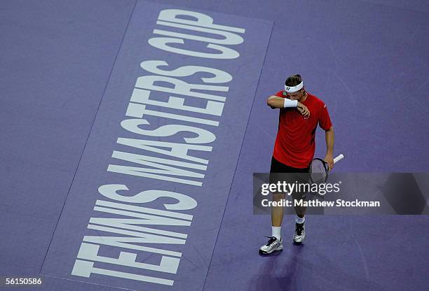 David Nalbandian of Argentina wipes his face between points against Roger Federer of Switzerland during the first round of the Tennis Masters Cup at...
