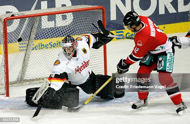 Dimitrij Kotschnew of Germany fighst for the puck with Chris Herperger of Canada during the TUI Nations Cup match between Canada and Germany at the...