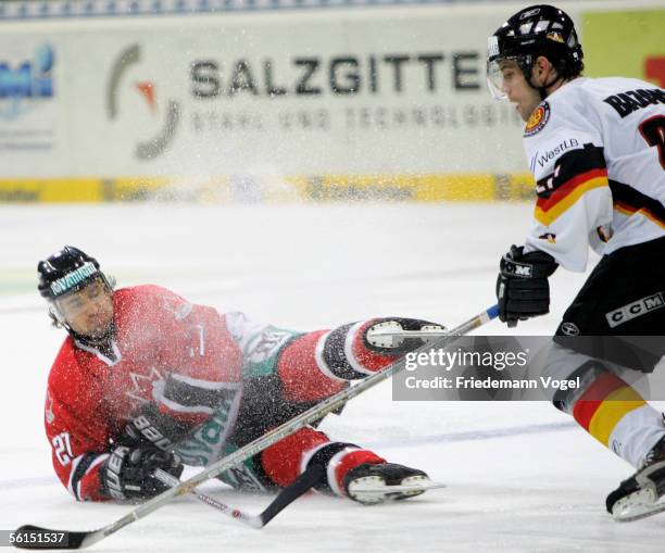 Marian Bazany of Germany fights for the puck with Scott King of Canada during the TUI Nations Cup match between Canada and Germany at the TUI Arena...