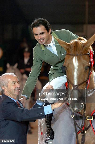 Brazilian Rodrigo Pessoa on Baloubet du Rouet celebrates with his father Nelson, organisator of the contest, after winning the Grand Prix in the...