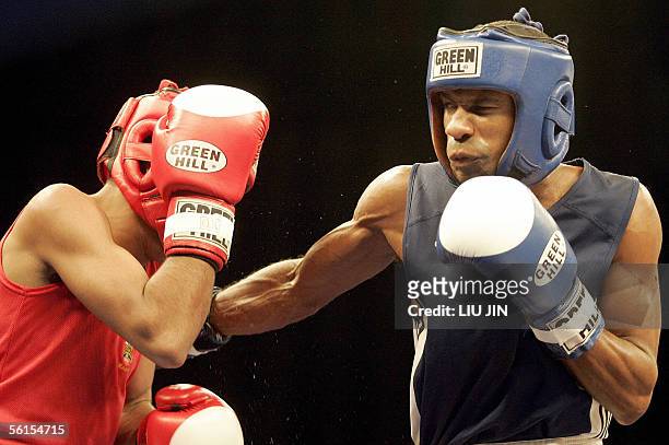 Yan Bartelemy Varela of Cuba fights M. Nasir of Wales during the 48kg category preliminary match of 13th World Senior Boxing Championships in...