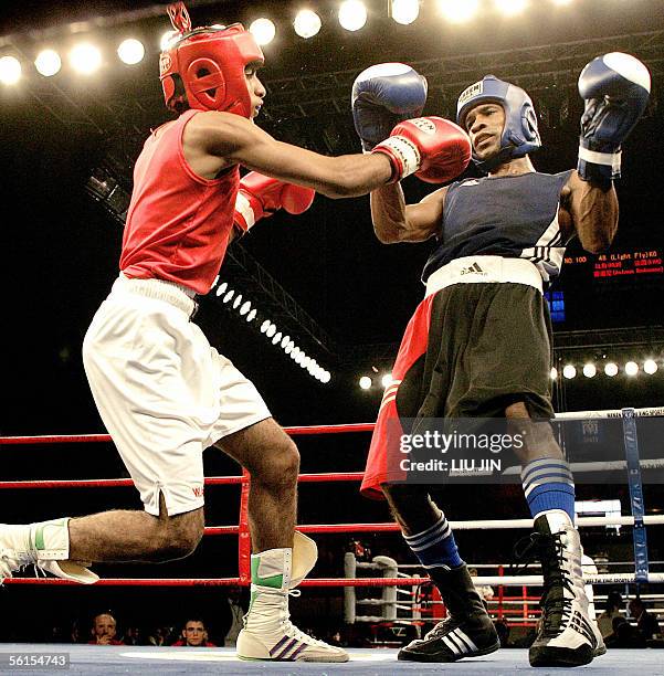 Yan Bartelemy Varela of Cuba fights M. Nasir of Wales during the 48kg category preliminary match of 13th World Senior Boxing Championships in...