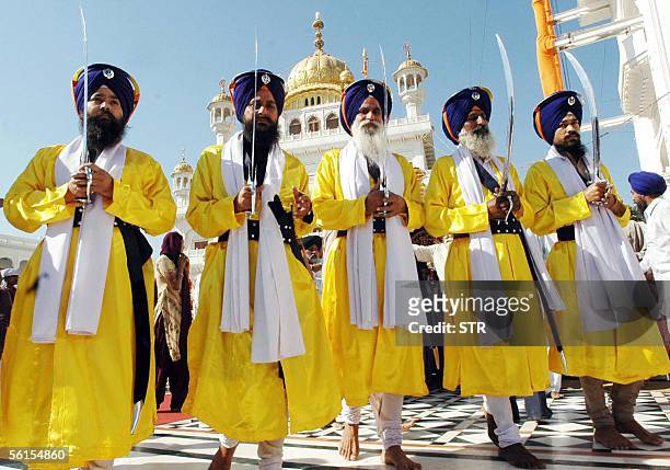 Indian Sikh devotees walk in a procession at the Golden Temple in Amritsar, 14 November 2005, on the eve of the 536th birth anniversary of Shri Guru...