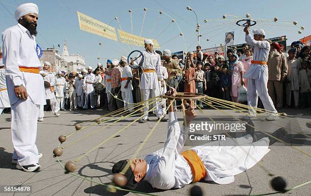 Indian Sikh devotees perform Gatka, a Sikh Martial Art during a celebration at the Golden Temple in Amritsar, 14 November 2005, on the eve of the...