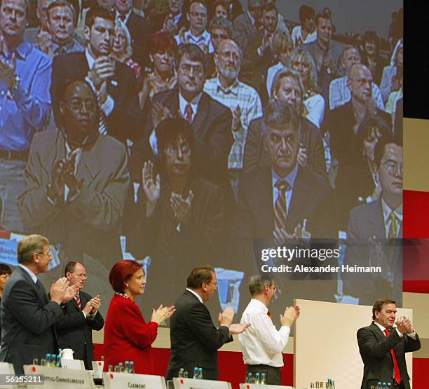 Members applause outgoing German Chancellor Gerhard Schroeder during a three-day party conference of the Social Democratic Party at the Messehalle on...